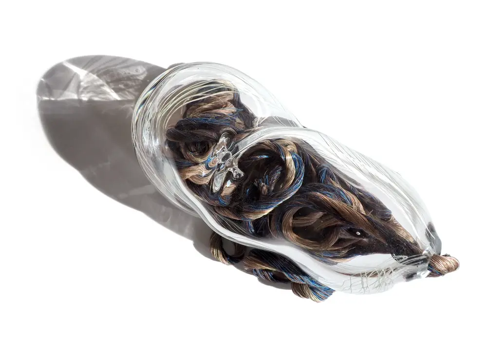 Blown glass cocoon sculpture — recycled textile fibers from waste, contemporary art, upcycling