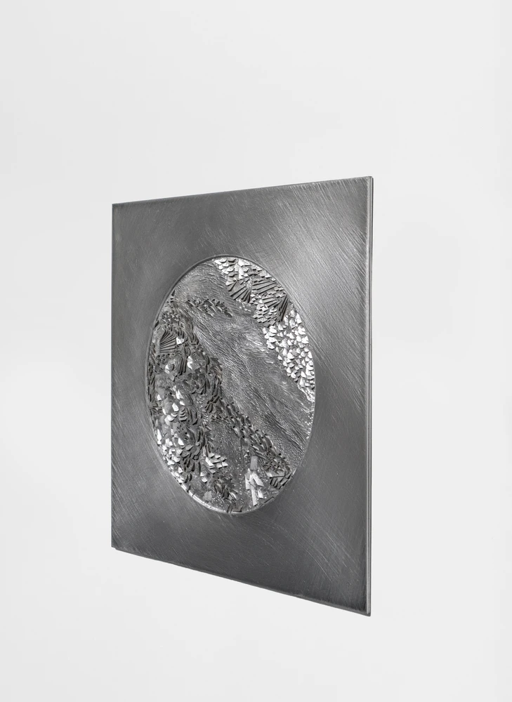 Engraved metal panel with landscape relief in circular form